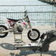 The Redshift SM’s naked frame in the foreground, completed motorcycle in the background.